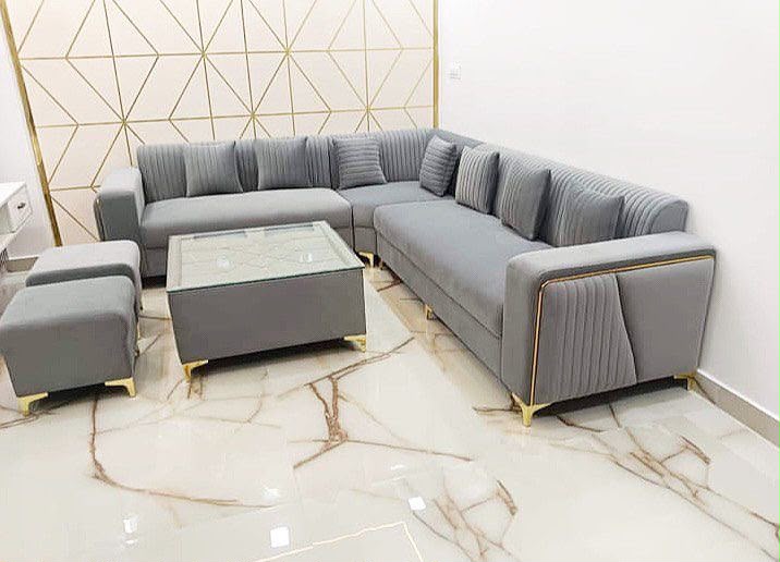 Gray L-shaped sofa with matching stools and center table