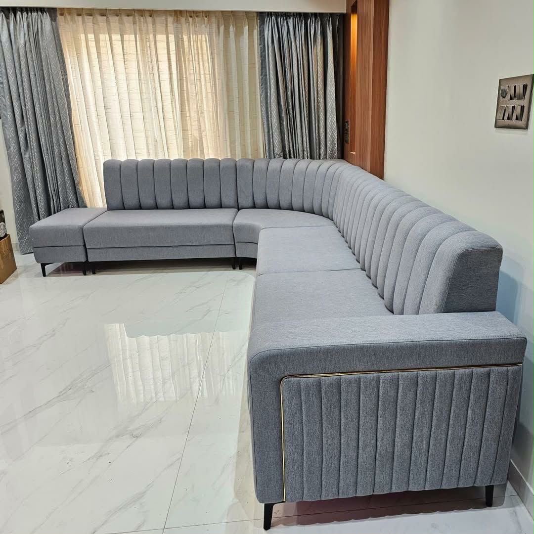 Large gray channel-tufted corner sofa